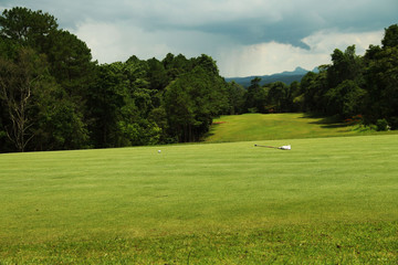 Background evening golf course has sunlight shining down at golf course in Thailand