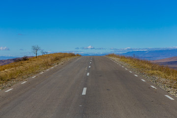 one old road in the field, clouds, landscape, sunny weather, Georgia, asphalt