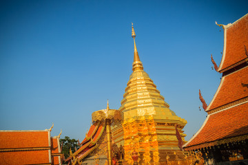 Fototapeta premium Beautiful northern Thai style architectural of golden church and pagoda at Wat Phra That Doi Suthep, the famous temple and became the landmark of Chiang Mai, Thailand.