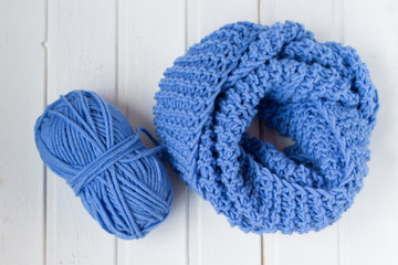 Woolen yarn bal. Knitted scarf on the white background