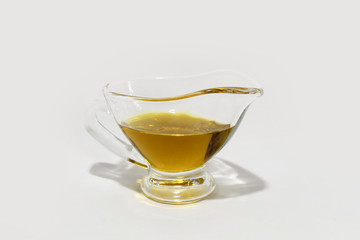 Bowl with olive oil on white background
