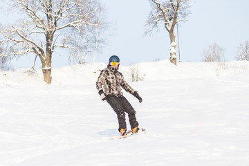 Fototapeta na wymiar Winter sport. Snowboarding in the mountains. Man on the board