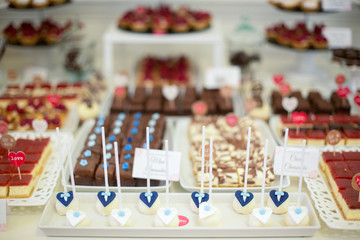 Delicious candy bar with cake pop, cakes, macarons and other sweets