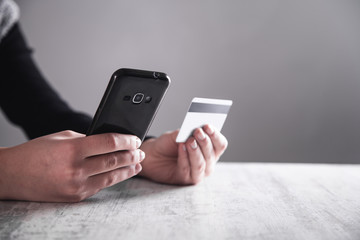 Hands with smartphone and credit card. Shopping