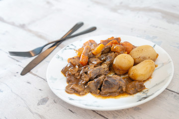 Beef meat stewed with potatoes-Traditional French cuisine Beef Bourguignon potatoes carrots in persillade