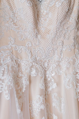 close-up of white lace with beautiful pattern on a wedding dress