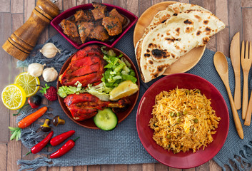Traditional Indian food chicken tandoori and Tikka with garlic naan