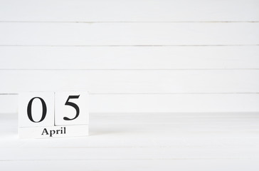 April 5th, Day 5 of month, National Maritime Day, Birthday, Anniversary, wooden block calendar on white wooden background with copy space for text.