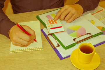 Savings, finances, economy, Business and home concept - man with calculator counting money and making notes at home