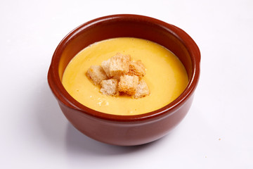 pumpkin cream soup with croutons on the white background