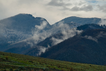 Russia. The South Of Western Siberia. mountain Altai. Fog in the mountains along the Chui tract.