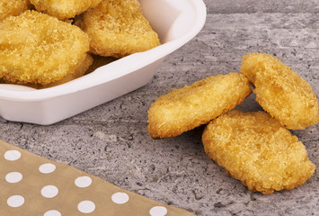 Chicken nuggets disposed on a concrete background. Fast food concept.