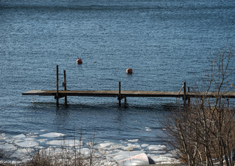 Jetty in Stockholm archipelago a sunny spring day with ice flakes