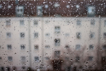 Drops of rain on glass , rain drops on clear window. Water condensation on transparent glass over city landscape or building in blur. - 250663930