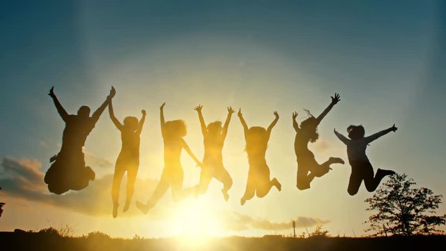 People Jumping at Sunset