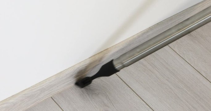 Vacuum cleaner rolling from side to side on a parquet floor