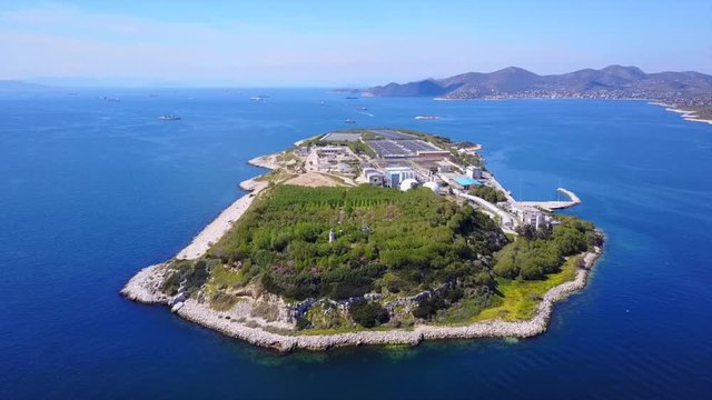 Aerial drone bird's eye video from island of Psytaleia the largest sewage treatment plant in Europe, Saronic gulf, Peiraeus, Attica, Greece