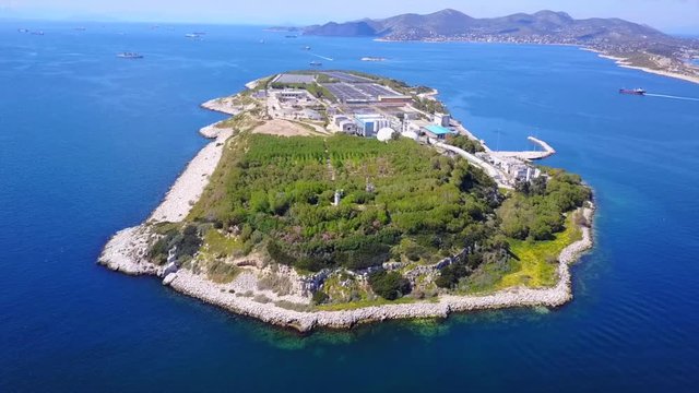 Aerial drone bird's eye video from island of Psytaleia the largest sewage treatment plant in Europe, Saronic gulf, Peiraeus, Attica, Greece
