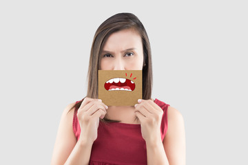 Asian woman in the red shirt holding a brown paper with the broken tooth cartoon picture of his...