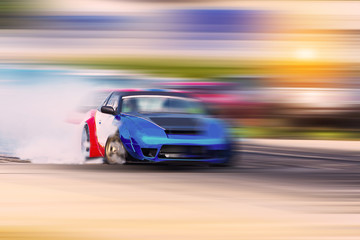 Fototapeta na wymiar Blurred Race car drifting on speed track on twilight background.