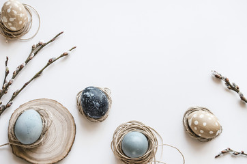 Pastel composition for the holiday of Easter. Colored eggs in natural colors. Background for the presentation of work or text. Top view. Copy space.  Mock-up