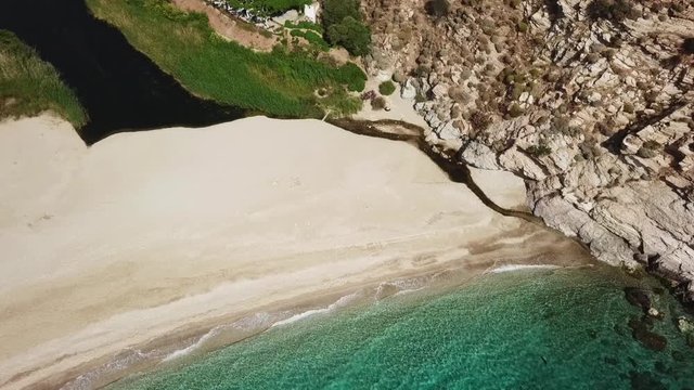 Aerial dorne bird's eye view video of iconic beach of Potami or River with turquoise clear waters, South Evia island, Greece