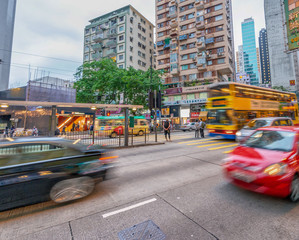 HONG KONG - MAY 10, 2014: City traffic with cars and taxis. Hong Kong hosts 10 million tourists every year
