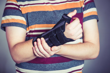 Man with hand in orthopedic black orthosis