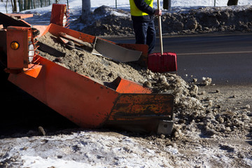 snow combine harvests dirty snow on the road. Gatchina, Russia. snow removal, reportage shooting.