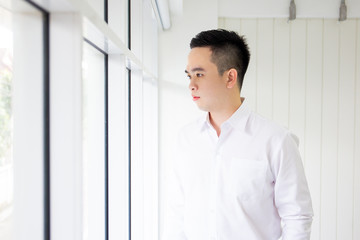 Portrait of smart Asian business man in formal white shirt close up.