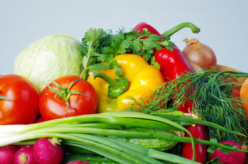 Appetizing vegetables. Tomatoes, cucumbers, onions, carrots, peppers, parsley.