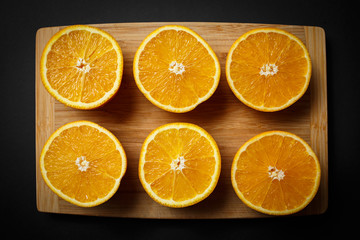 cut orange on wooden background