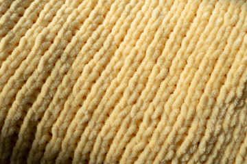 Background texture of microfibre yellow yarn located diagonally