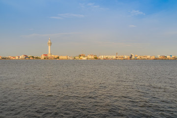 Naklejka premium Riverfront view of Samut Prakan city hall with new observation tower and boat pier. Samut Prakan is at the mouth of the Chao Phraya River on Gulf of Thailand.