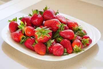 The plate with fresh strawberry