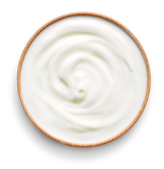 Delicious yogurt scene with wooden bowl, isolated on white background. Closeup shot of healthy fresh yogurt or cream. Top view.