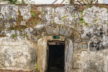 Fototapeta na wymiar Old cave of gun at Phi Sua Samut Fortress or Pom Phi Sua Samut is a fortress island and built in 1819 on the Chao Phraya river and now being turned into a tourist attraction.