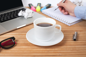 Business, education, people and technology concept - close up of male hands with laptop and coffee cup