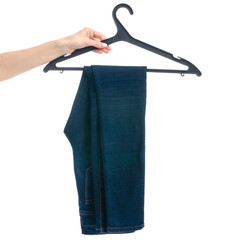 Blue jeans on hanger in hand on white background isolation