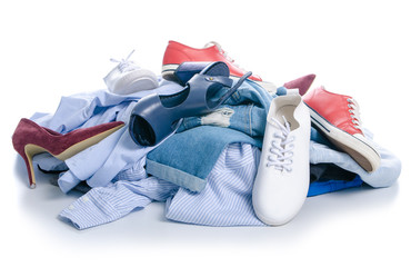 A pile of clothes and shoes on a white background. Isolation