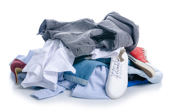 A pile of clothes and shoes on a white background. Isolation