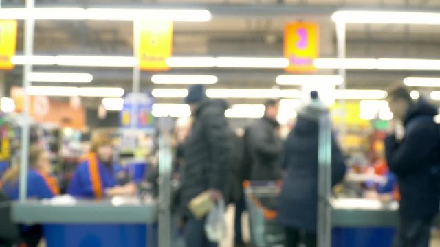 Blurred supermarket store at the cashier line people doing shopping christmas holidays