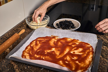 woman hands working on a pizza dough