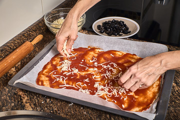 woman hands working on a pizza dough