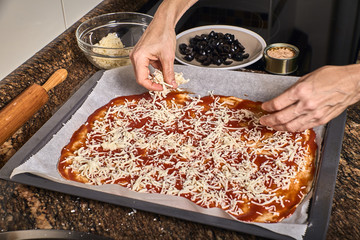 woman hands working on a pizza dough