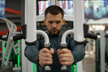 Fototapeta na wymiar Man in the gym with kettlebells and weights.