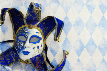 blue with gold elegant traditional venetian mask over white wooden background