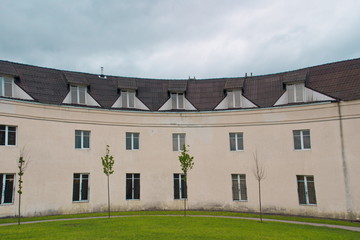 Image of white three-storey rounded residential building