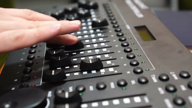 Male hand using mixing console, Sound recording studio mixing desk with engineer or music producer