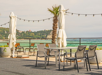 Street cafe on the sea promenade